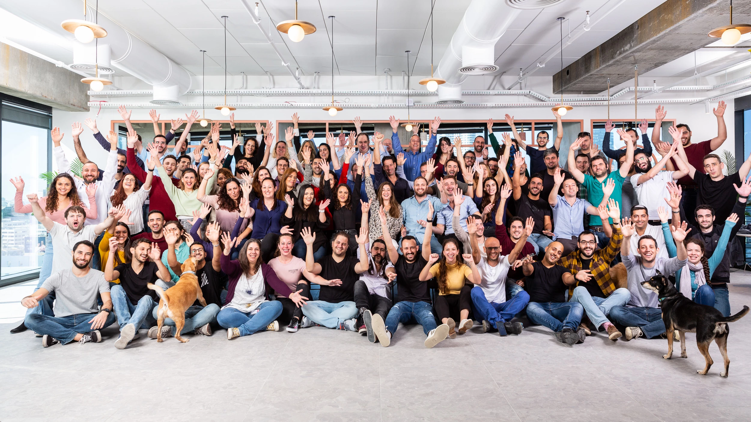 Claroty employees celebrating at a gathering in the company office.